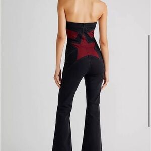 Free People Trinity Jumpsuit in black with red star detail — Size 0.